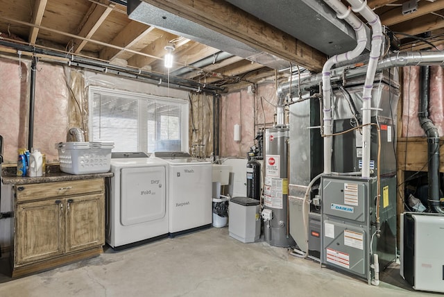 below grade area with gas water heater, heating unit, and independent washer and dryer