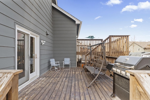 wooden deck featuring area for grilling