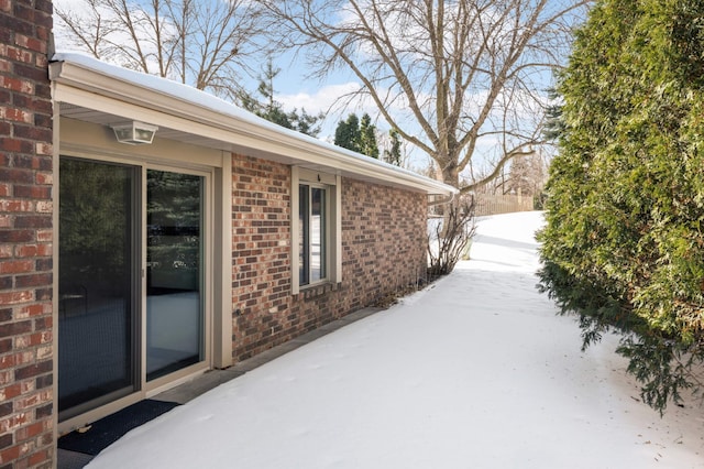 view of property exterior featuring a patio and brick siding