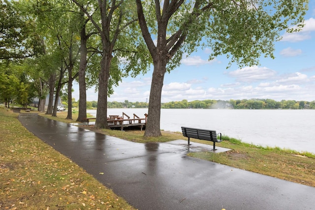 view of community with a water view and a boat dock