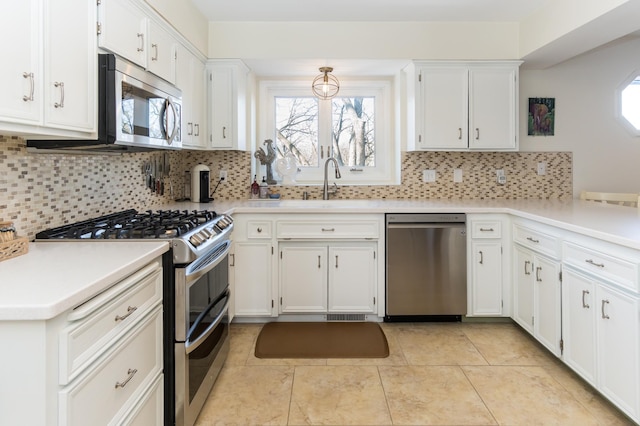 kitchen with white cabinetry, a healthy amount of sunlight, backsplash, and stainless steel appliances