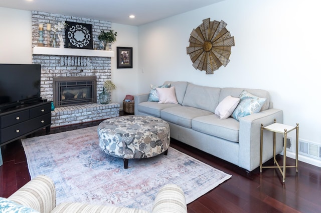 living area with recessed lighting, visible vents, wood finished floors, and a fireplace