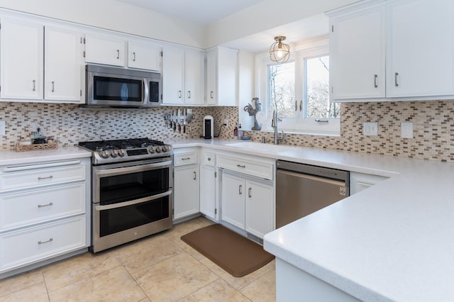 kitchen featuring white cabinets, tasteful backsplash, and appliances with stainless steel finishes