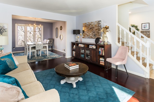 living area with a notable chandelier, stairway, baseboards, and wood finished floors