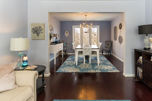 dining space with an inviting chandelier, wood finished floors, and baseboards