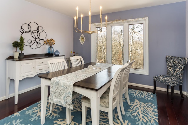 dining area featuring baseboards, a notable chandelier, and dark wood-style floors