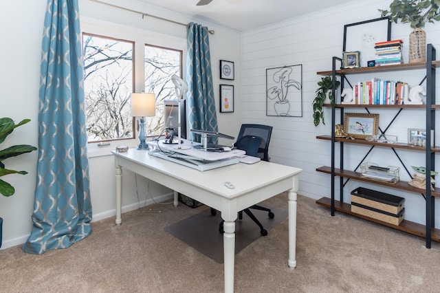 carpeted office space featuring baseboards, ceiling fan, and ornamental molding