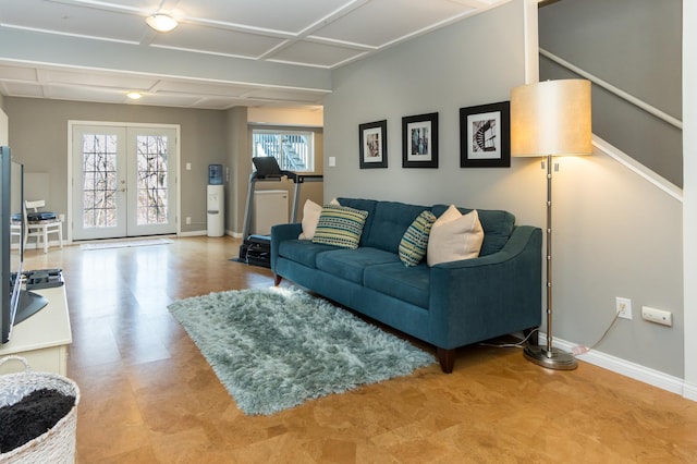 living room with french doors and baseboards