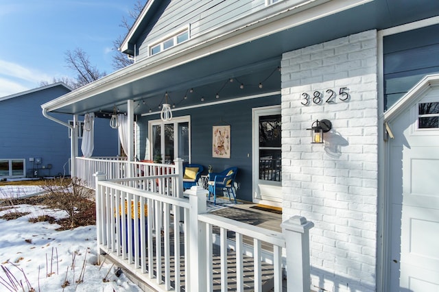 property entrance featuring brick siding and a porch