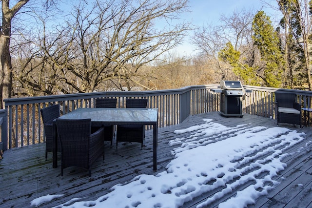 wooden deck with a grill and outdoor dining area