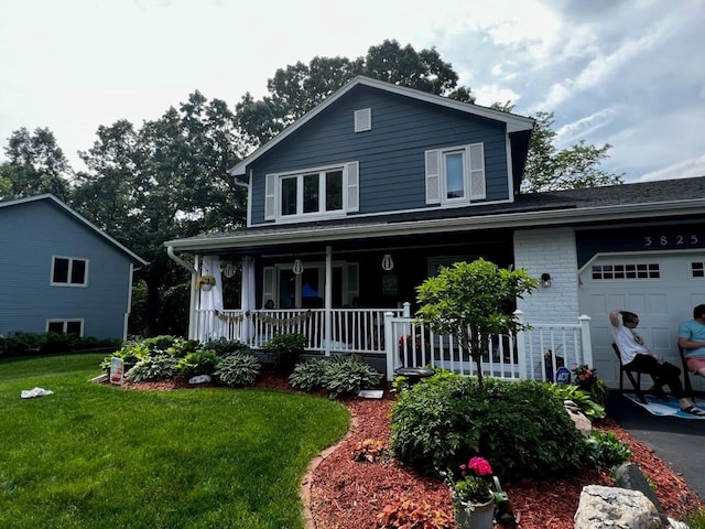 view of front of house featuring a garage, brick siding, a porch, and a front lawn