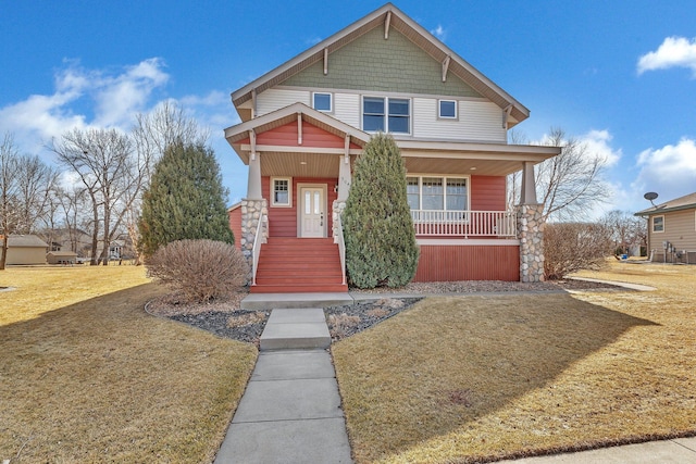 craftsman-style house featuring a porch and a front yard