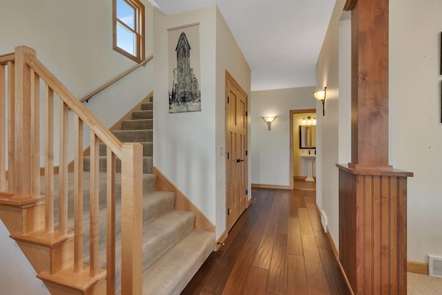 interior space with hardwood / wood-style floors, baseboards, and visible vents