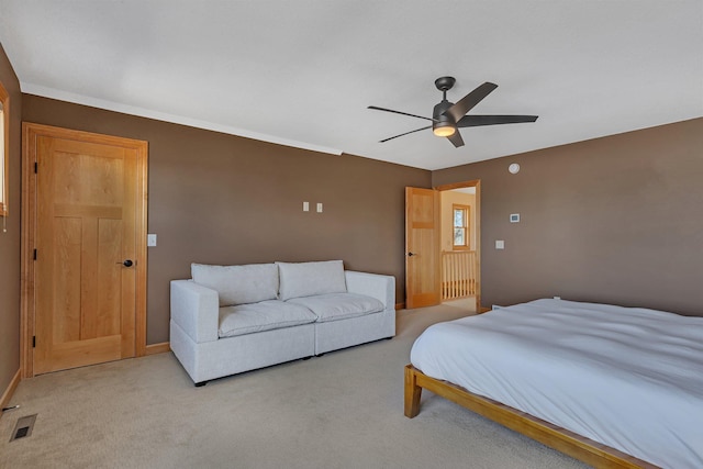 bedroom with visible vents, baseboards, light colored carpet, and a ceiling fan