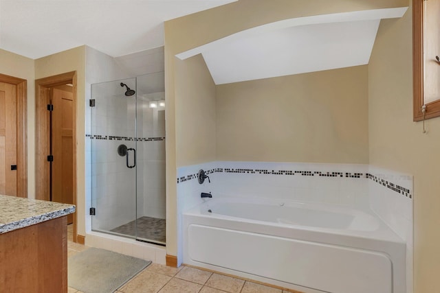 full bath with vanity, tile patterned floors, a bath, and a stall shower