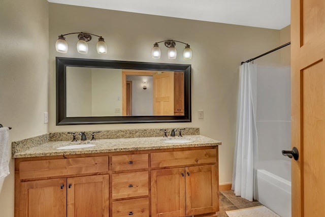 full bath with double vanity, shower / tub combo, tile patterned floors, and a sink