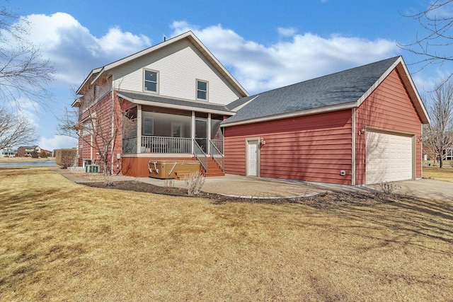 back of house featuring a lawn, driveway, roof with shingles, an attached garage, and central AC unit