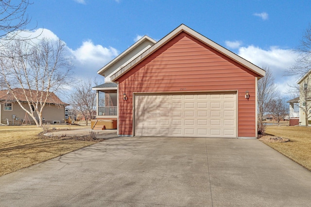 exterior space with concrete driveway, a yard, and a garage