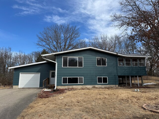 view of front of property with aphalt driveway and an attached garage