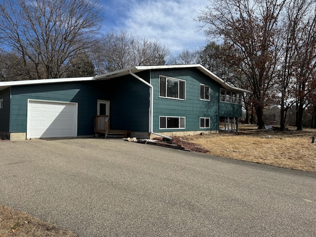 view of front of house with aphalt driveway and an attached garage