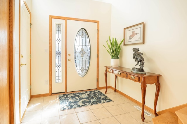 entryway with light tile patterned floors, visible vents, and baseboards