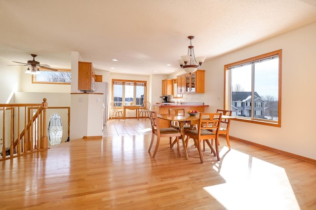 dining area with baseboards, recessed lighting, ceiling fan, light wood-style floors, and a textured ceiling