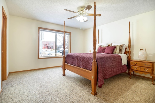 bedroom featuring ceiling fan, baseboards, carpet floors, and a textured ceiling