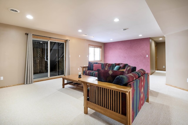 carpeted living area featuring recessed lighting, visible vents, and baseboards