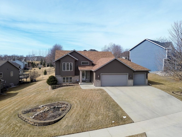 view of front of property featuring brick siding, a shingled roof, a front yard, driveway, and an attached garage