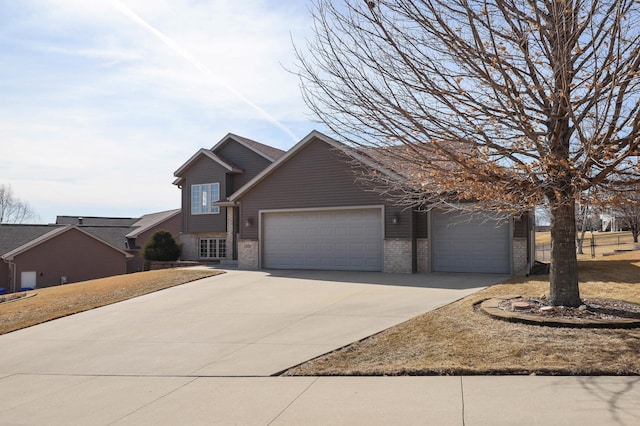 view of front facade featuring a garage, brick siding, and driveway