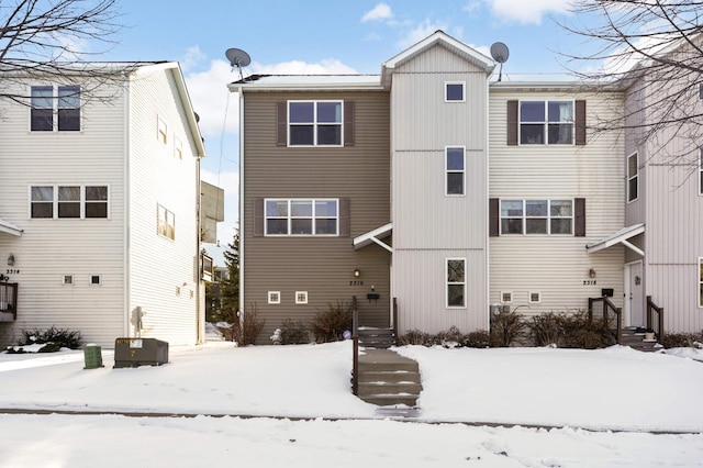 view of snow covered rear of property