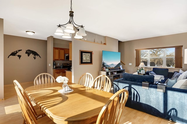 dining room featuring a chandelier and light wood-style floors