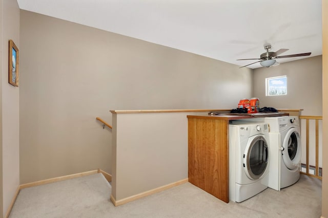 washroom with light carpet, a ceiling fan, washer and dryer, baseboards, and laundry area