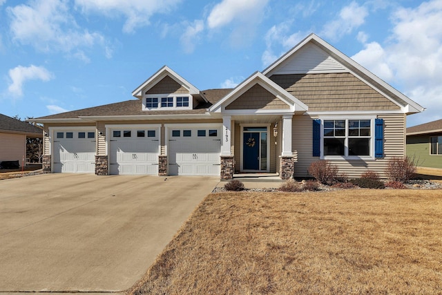 craftsman inspired home with stone siding, driveway, a front yard, and a garage