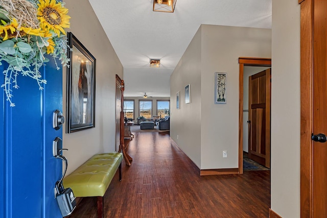 foyer featuring wood finished floors and baseboards