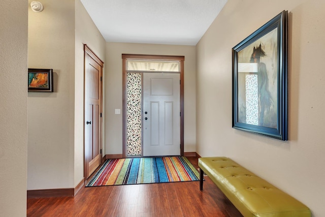 foyer entrance featuring wood finished floors and baseboards