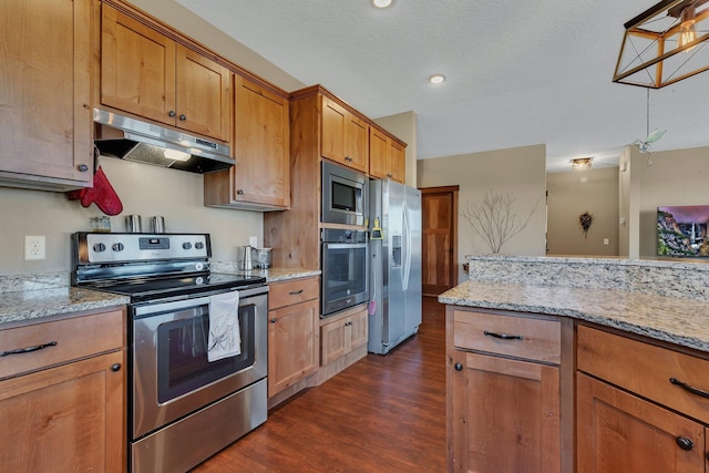 kitchen featuring under cabinet range hood, light stone countertops, stainless steel appliances, and dark wood-style flooring