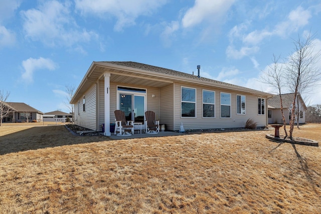 back of property featuring a yard and a patio area