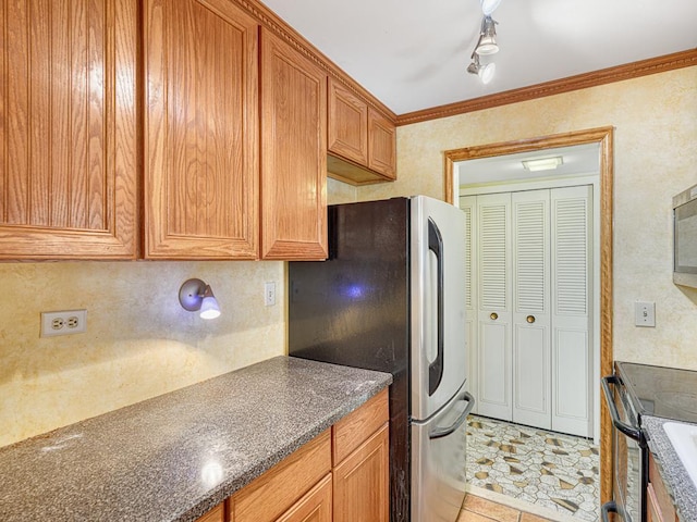 kitchen with crown molding, brown cabinetry, and stainless steel appliances