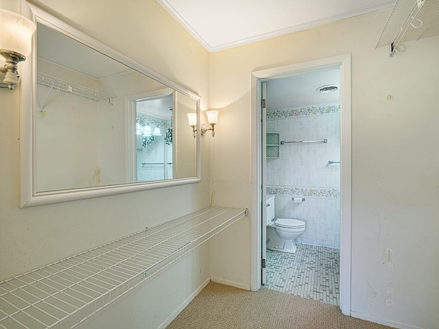 bathroom featuring toilet, visible vents, and ornamental molding