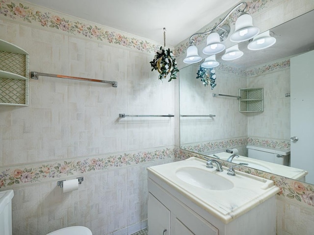 bathroom with vanity, tile walls, and toilet