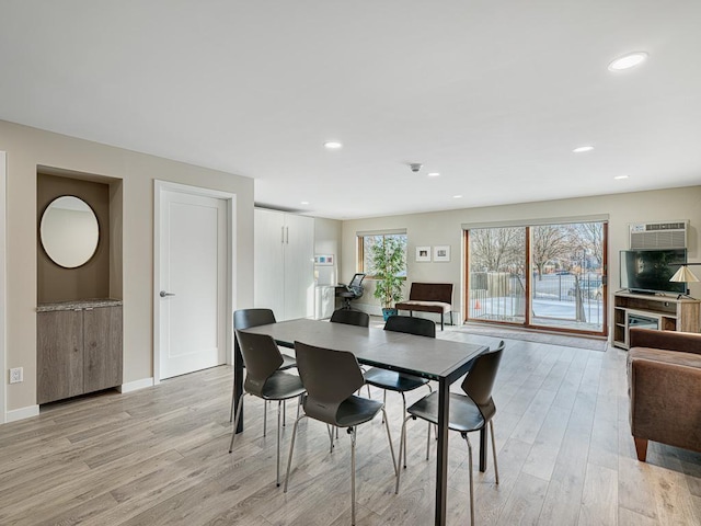 dining area featuring recessed lighting, baseboards, light wood finished floors, and a wall mounted AC