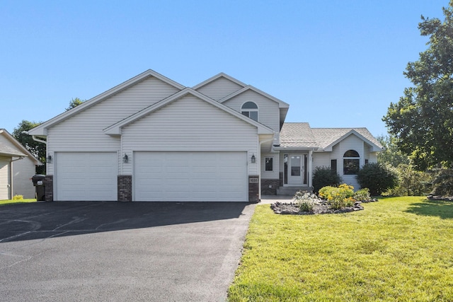 view of front of home featuring a garage, driveway, and a front lawn