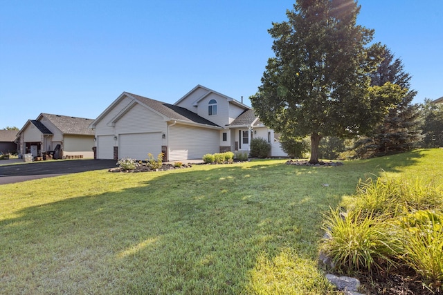 traditional-style home with a front yard, an attached garage, and aphalt driveway