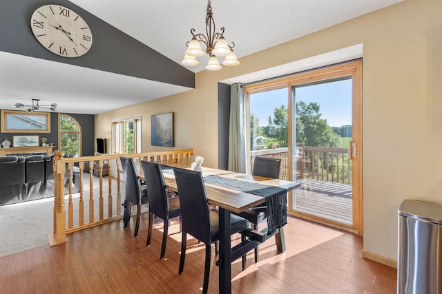 dining room featuring an inviting chandelier, light wood-style flooring, a healthy amount of sunlight, and baseboards