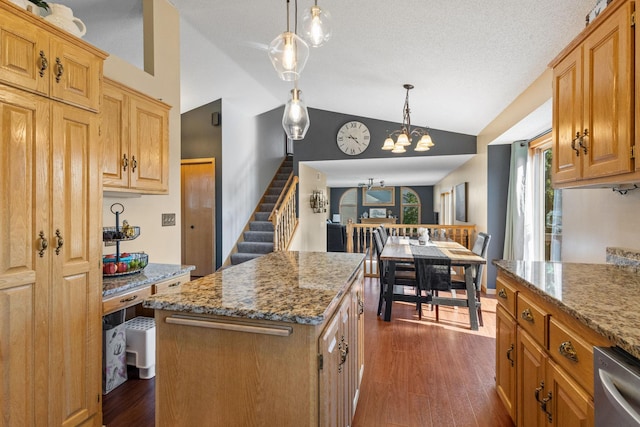 kitchen featuring light stone counters, lofted ceiling, and dark wood-style flooring