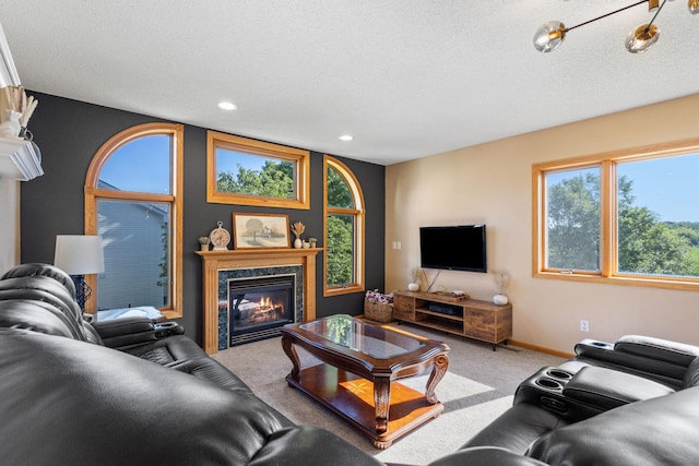 carpeted living area featuring a textured ceiling, recessed lighting, baseboards, and a premium fireplace