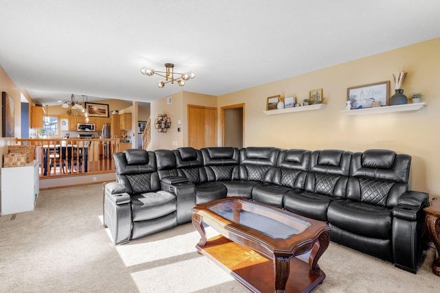 living area with carpet floors and an inviting chandelier