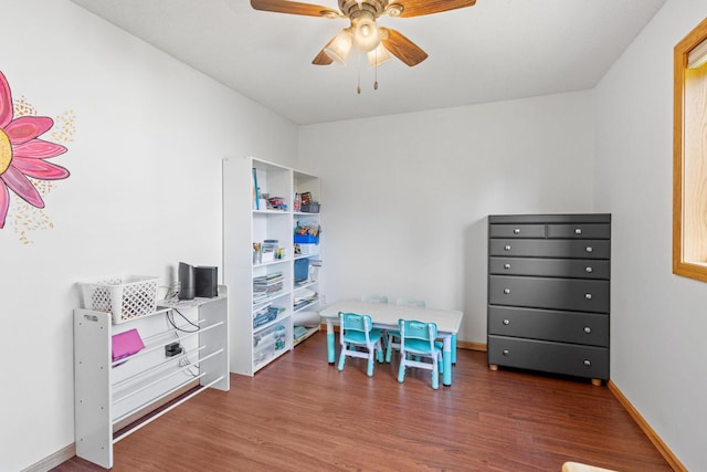 rec room with ceiling fan, baseboards, and wood finished floors