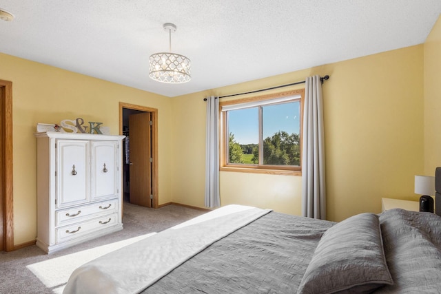 bedroom featuring light colored carpet and baseboards